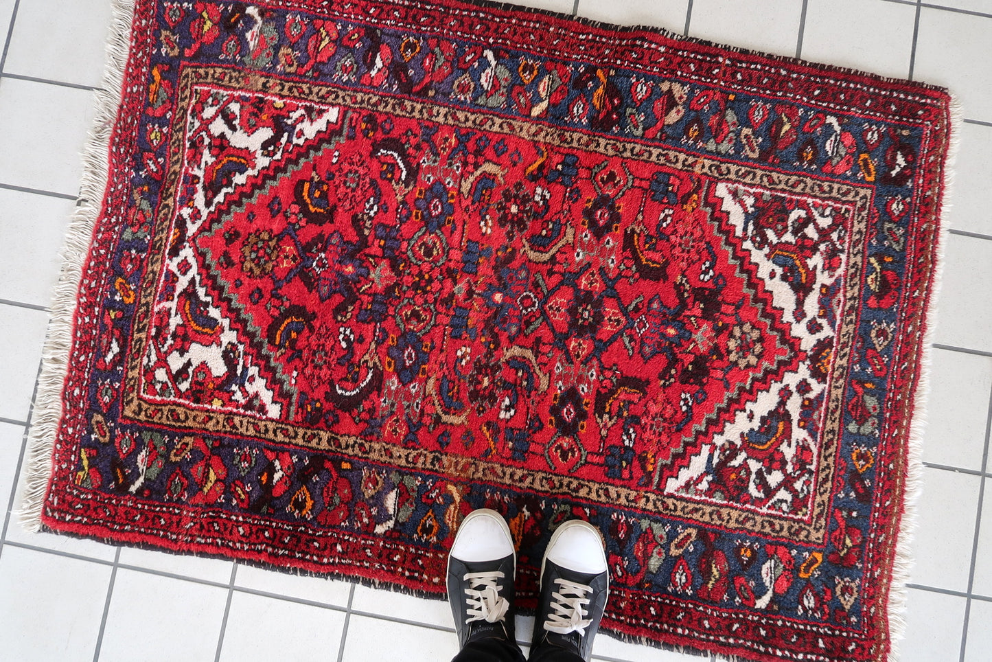 Vintage red and navy Persian rug with ivory accents
