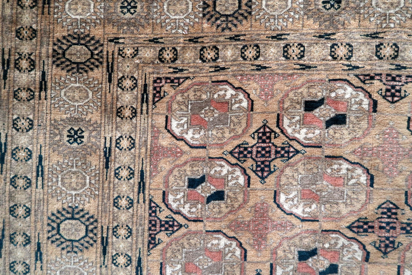 Handwoven Afghan rug with traditional oval pattern