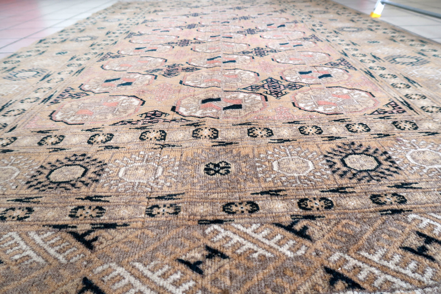 Detailed view of geometric patterns on vintage Afghan rug