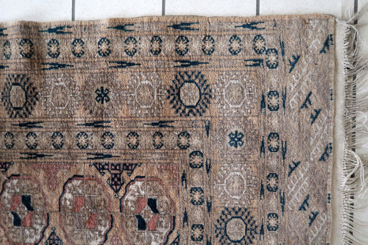 Reddish-brown Afghan rug with oval geometric patterns