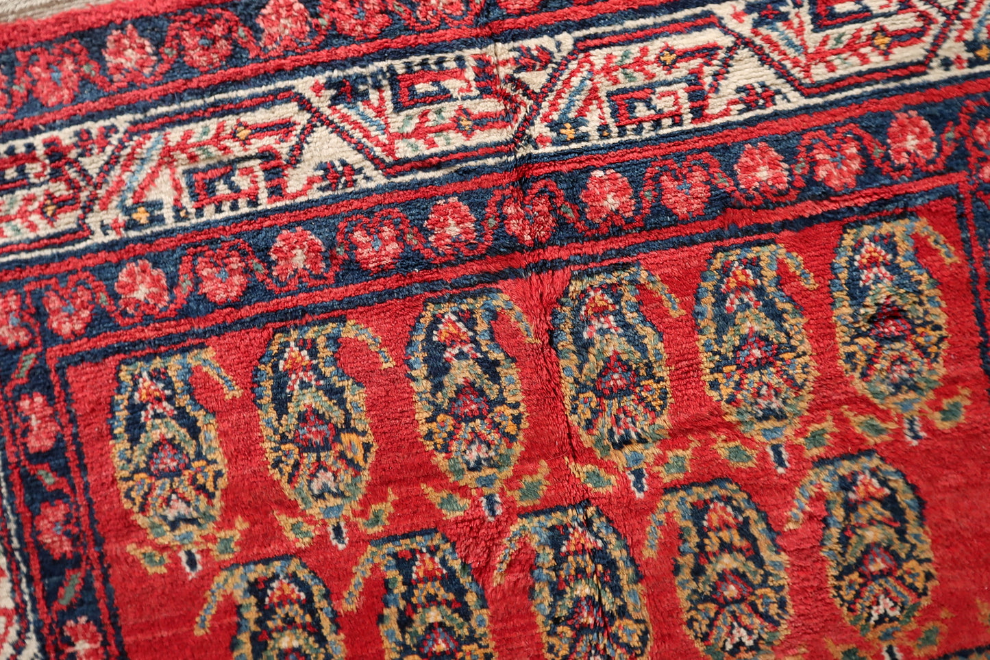 Detail of the guard stripes and main border framing the Hamadan rug's design.