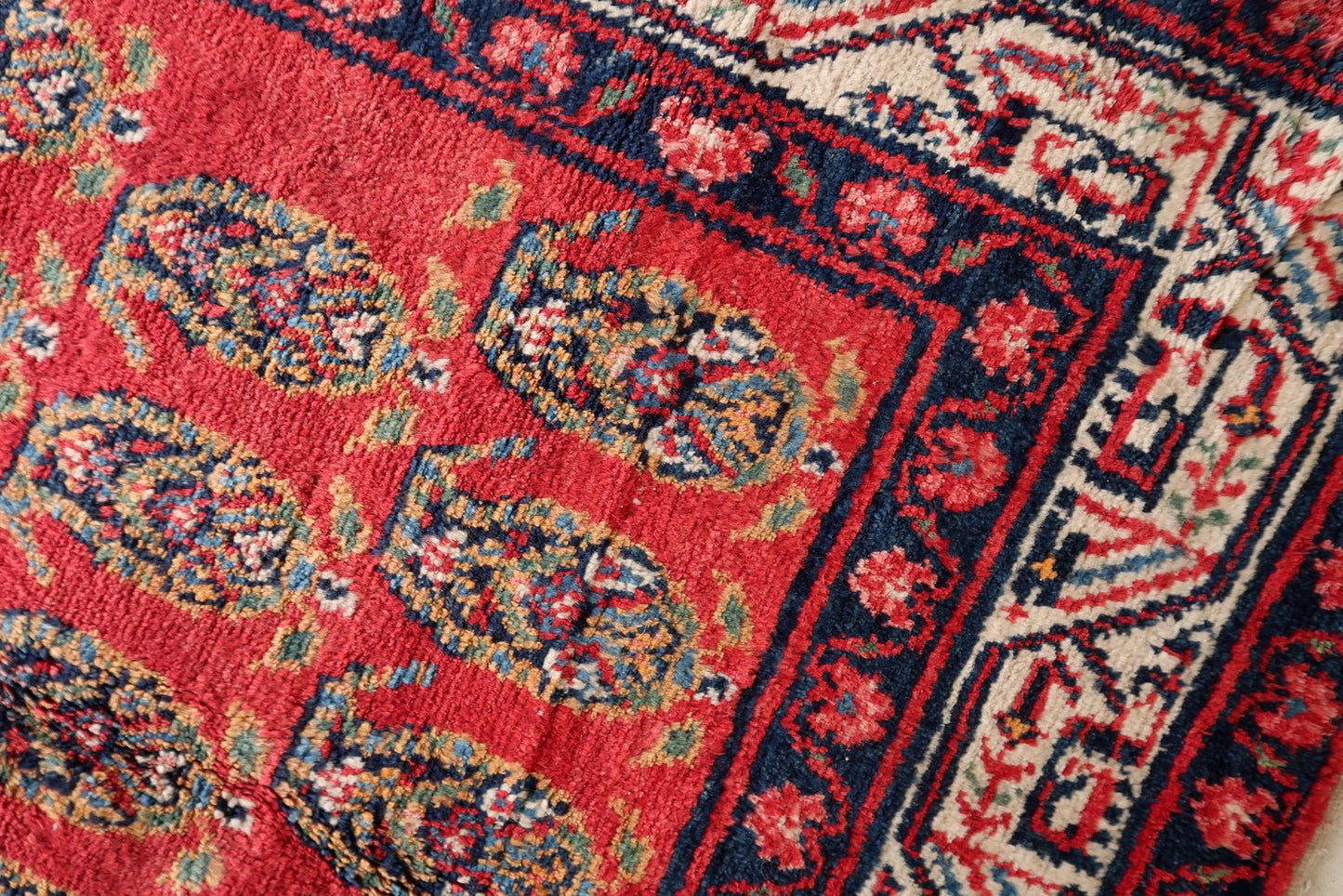 Detail of the main border with its continuous geometric design in navy and ivory.