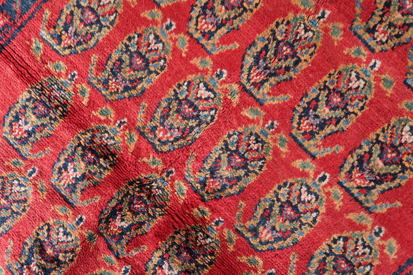 Close-up on the intricate knotting and weaving details of the Persian rug.