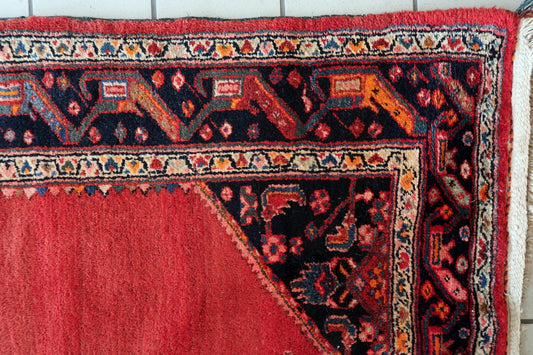 Close-up of the large geometric medallion in navy blue and red.