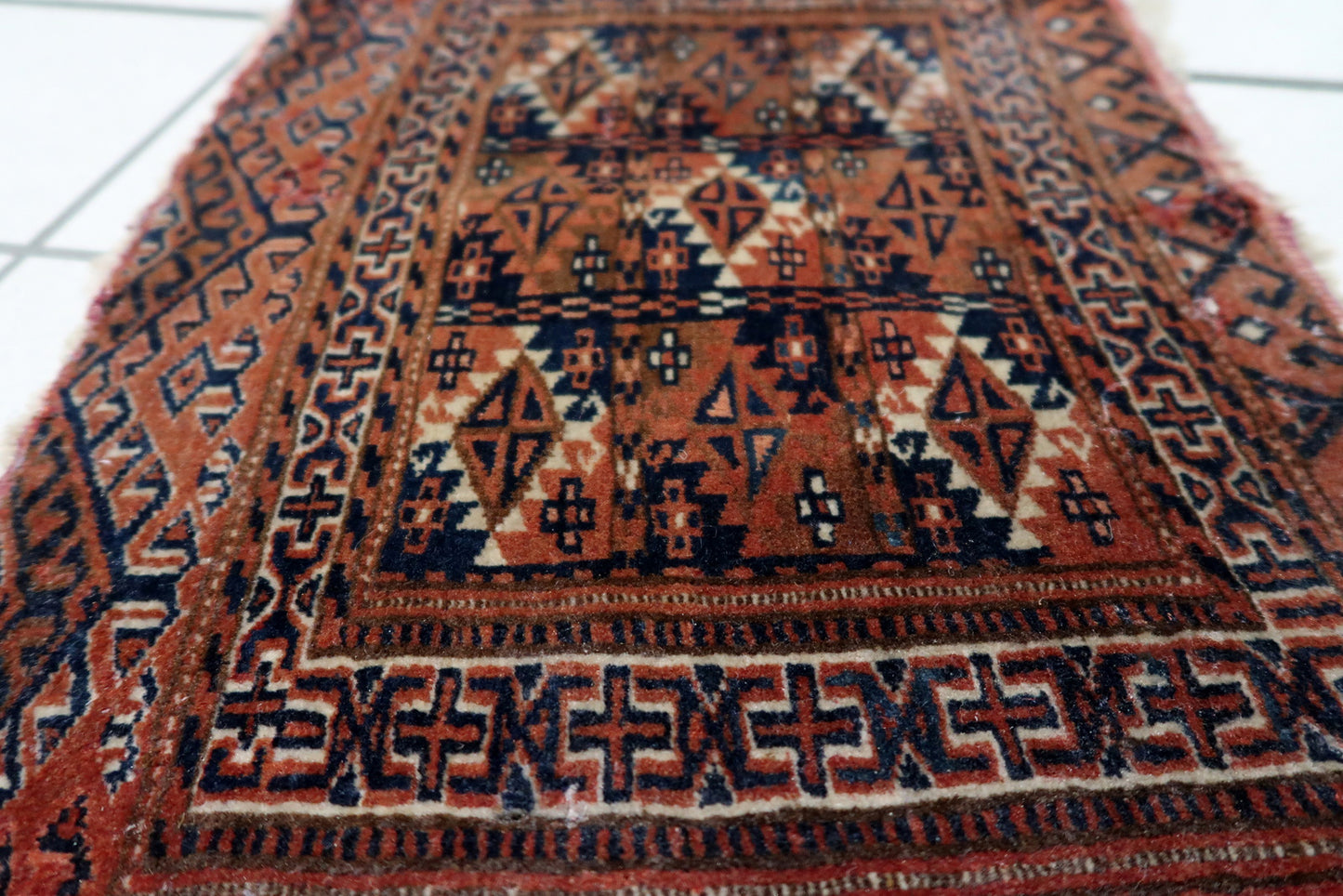 Terracotta accents within the traditional tribal motifs