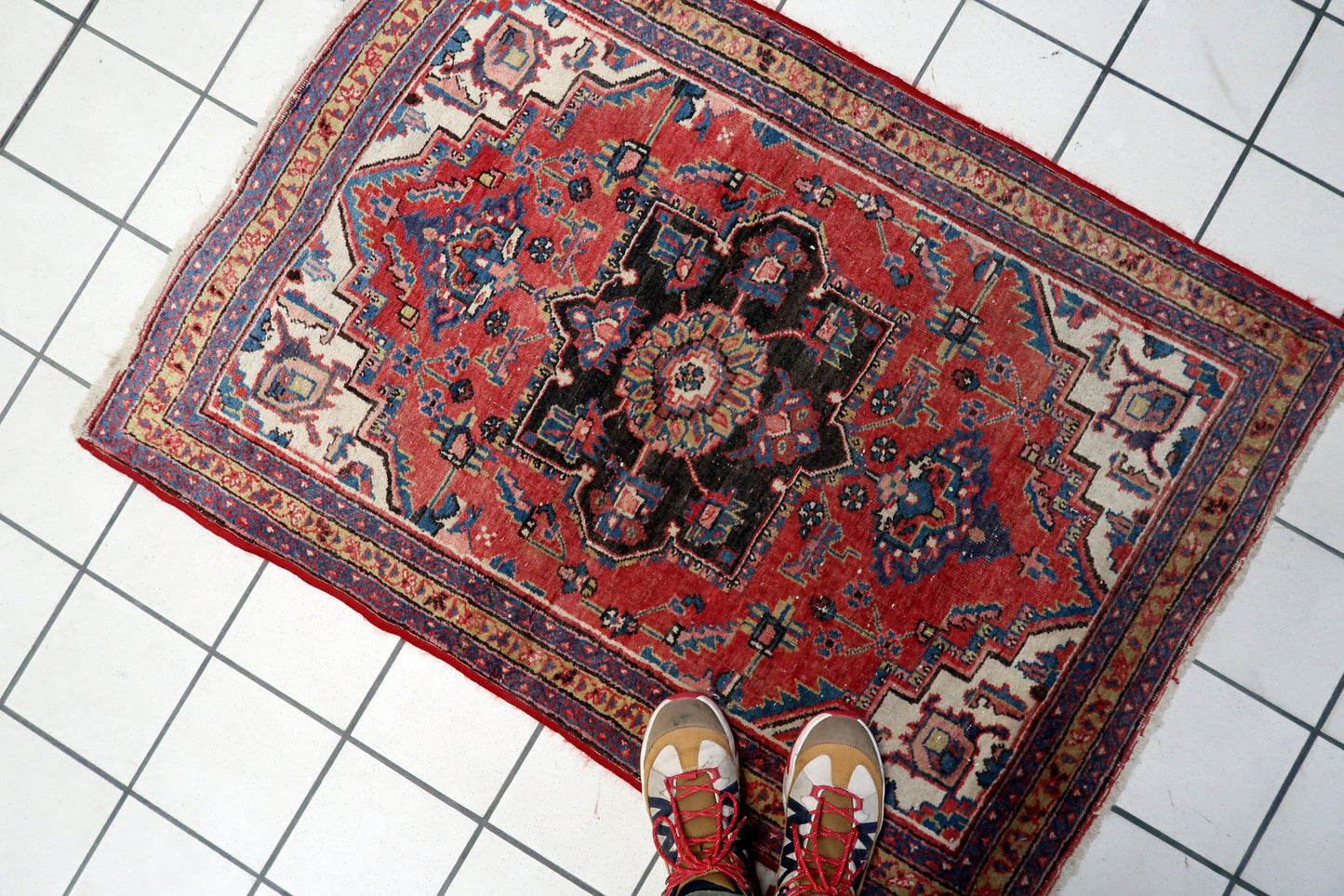 Close-up on the minor, gentle wear that authenticates the rug's century of age.