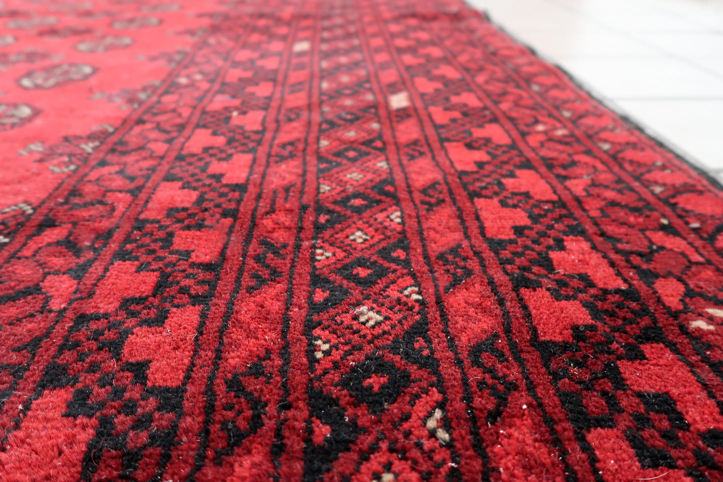 Vintage Central Asian rug, coral-red field with octagonal medallions and multiple borders.