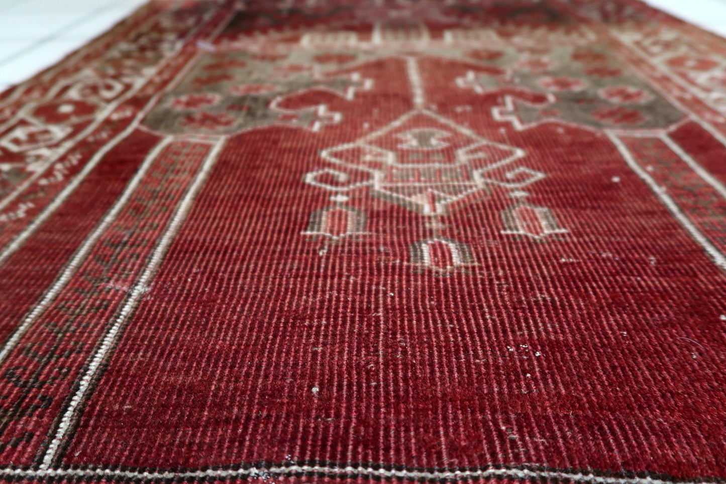 Antique Turkish Konya prayer rug with soulful, distressed character, ideal as a wall hanging to display its sacred textile artistry.