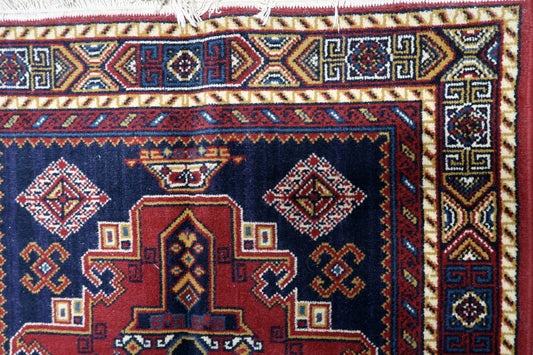 Persian-style carpet geometric motifs red navy black fringed ends