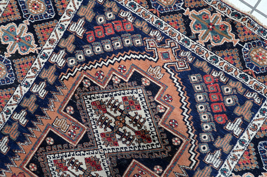 Early 20th-century Persian Afshar rug, 3.8 x 4.6 feet, with intricate geometric and floral borders in deep navy, rust, red, and green tones.