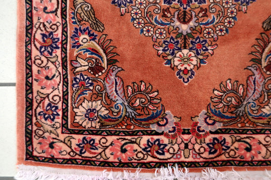 Hand‑knotted Sarouk accent rug featuring warm terracotta rose field and floral medallion