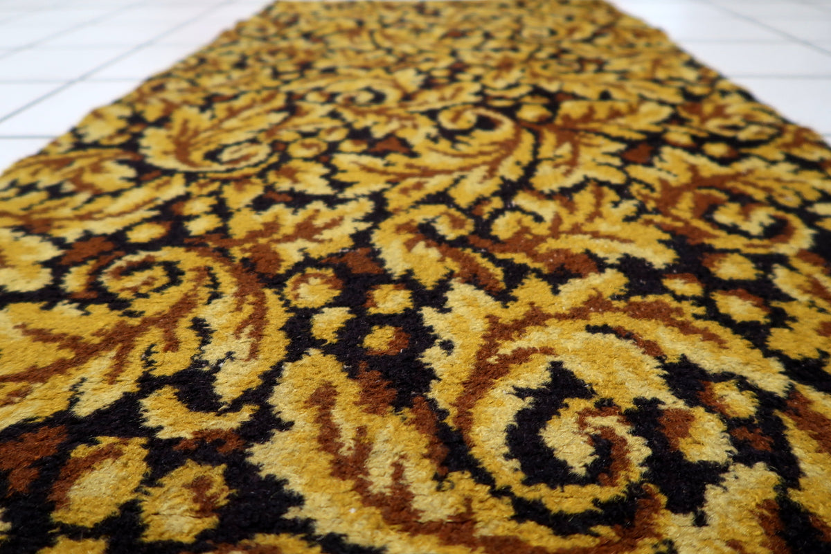 Low-maintenance colorfast acrylic fiber weave construction on a 1960s West German vintage accent rug.