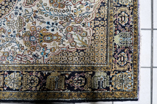 Fine hand-knotted Kashmir silk accent rug featuring a symmetrical central medallion on a lustrous ivory and ruby field.