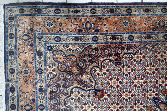 Hand-knotted 1940s oriental room-size area rug displaying a central medallion composition with intricate floral spandrels and traditional borders.
