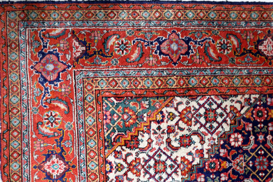 Hand-knotted 1940s room-size oriental carpet displaying a central medallion composition with intricate floral spandrels and traditional borders.