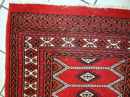 Close-up view of the intricate wool weaving in the vintage Lahore rug from Pakistan.