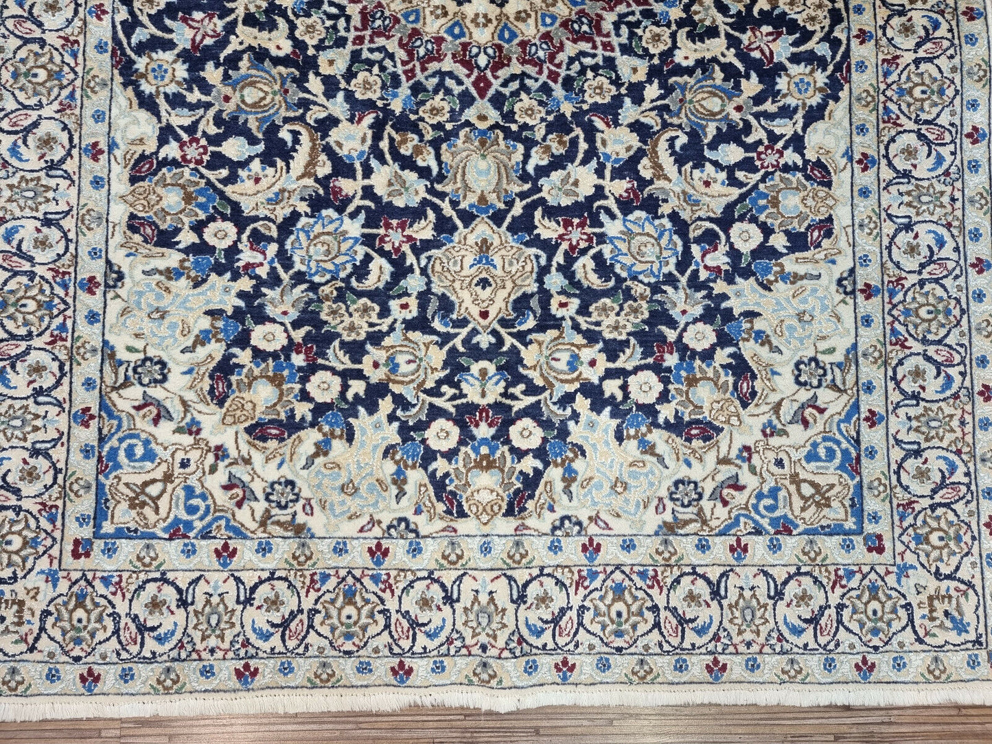 Vintage Persian-style Nain rug displayed on hardwood floor
