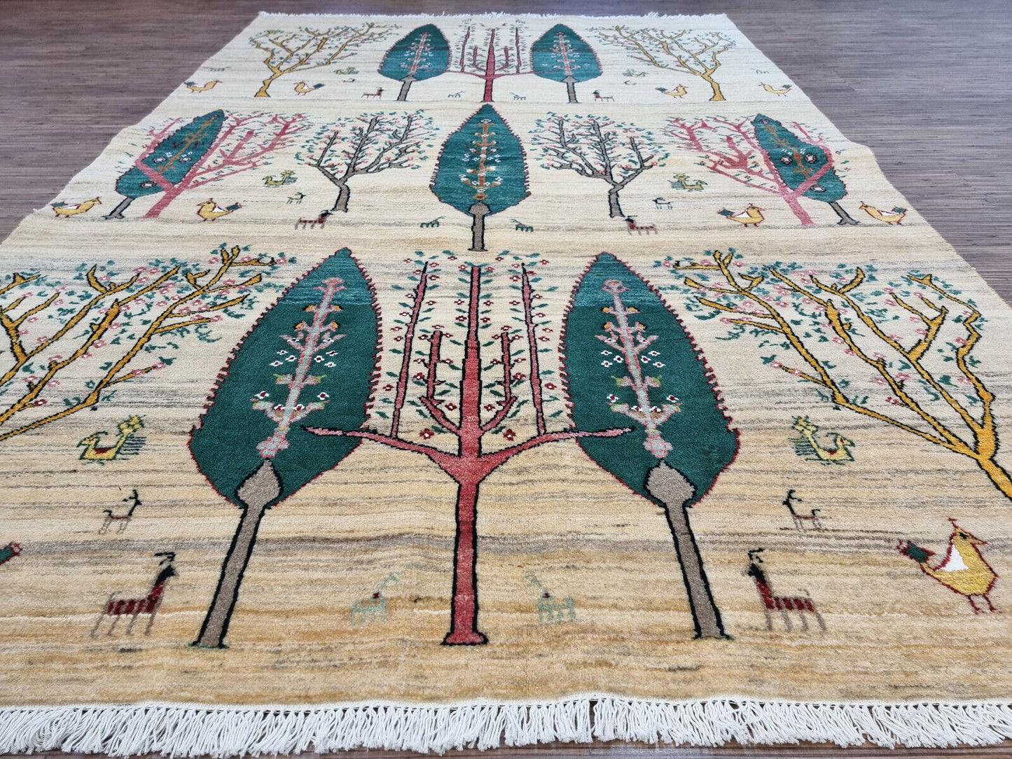 Cream background with vibrant trees and birds on the Gabbeh rug