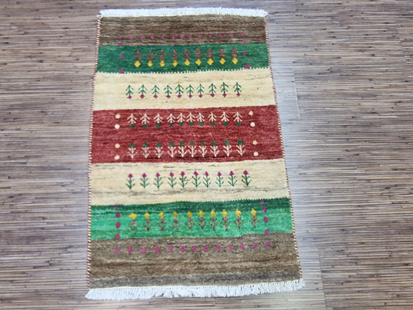 Persian Gabbeh rug rolled up with visible tags