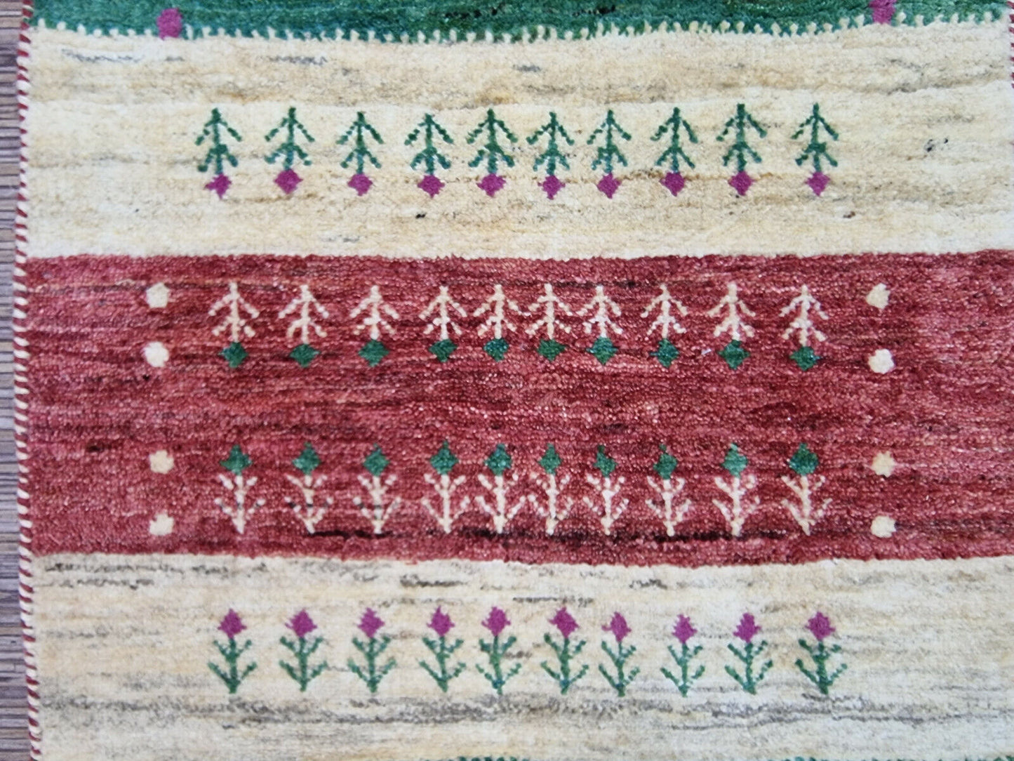 Close-up of hand-knotted tree motif on Persian Gabbeh rug