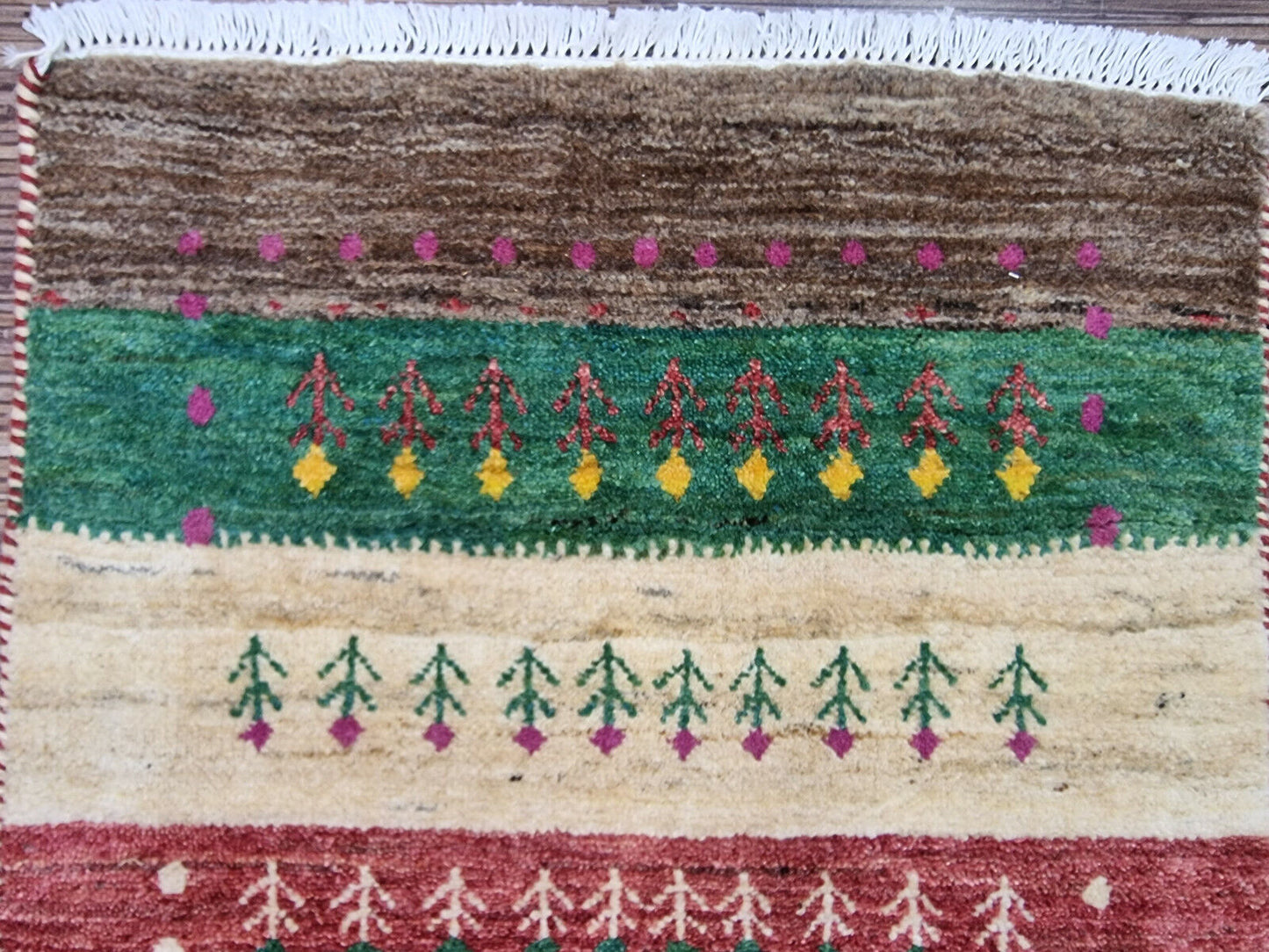 Rectangular Persian Gabbeh rug on hardwood floor