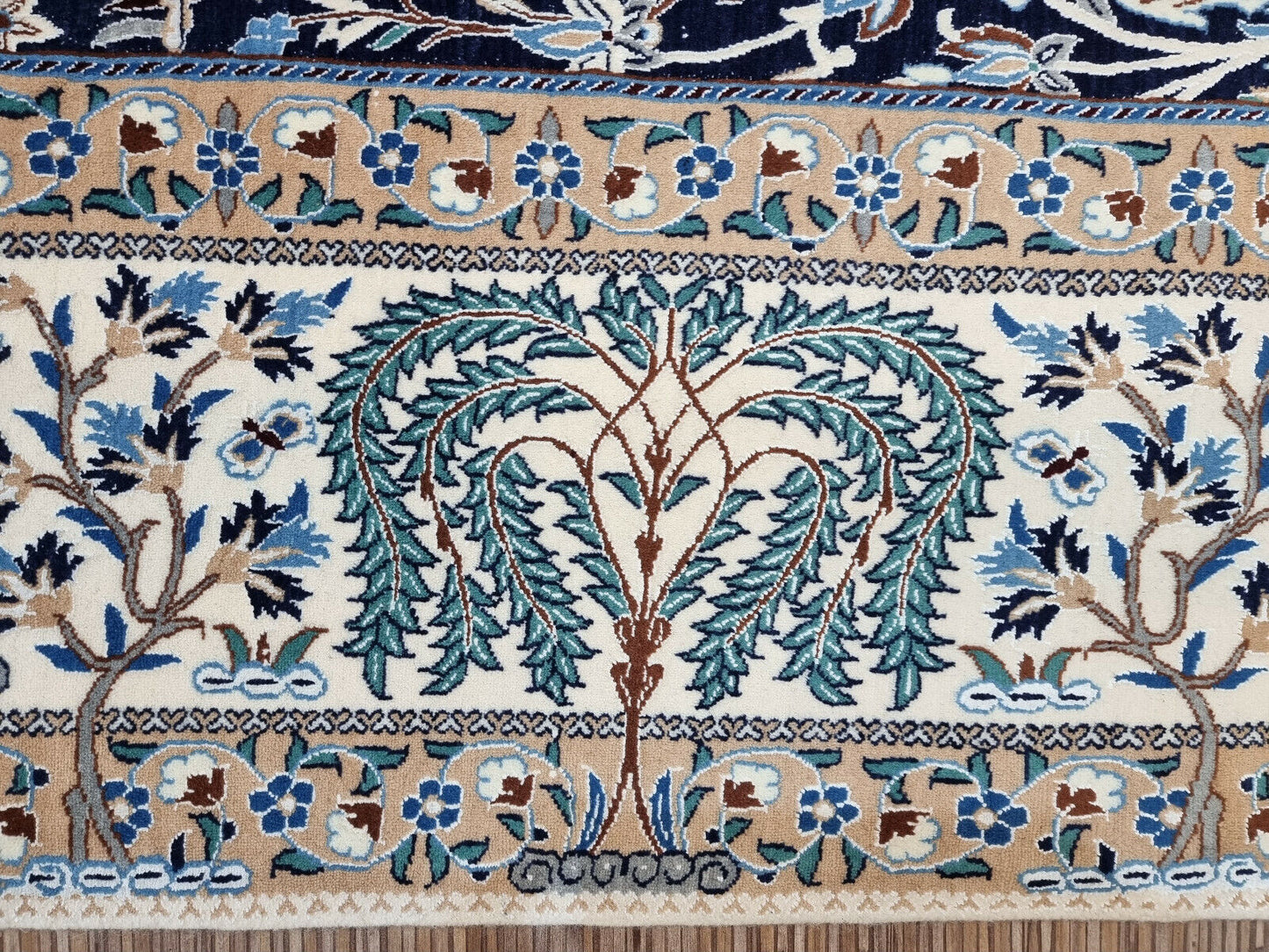 Floral vine patterns on Persian Nain carpet