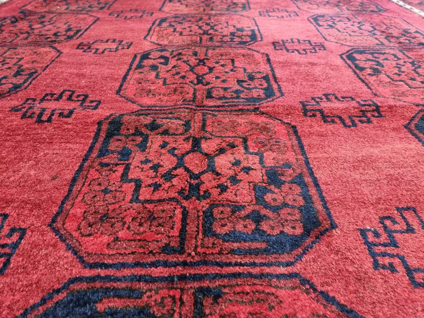 Hand-knotted Afghan wool carpet in bold red tones