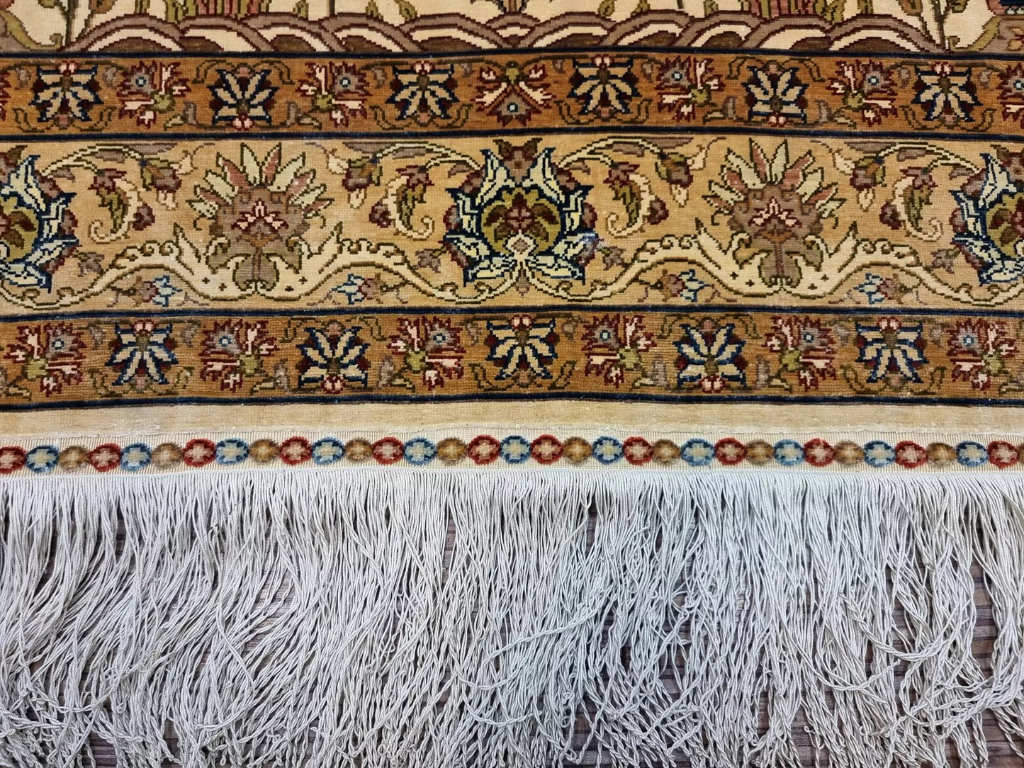 Close-up of the hand-knotted Hereke prayer rug with a medallion centerpiece