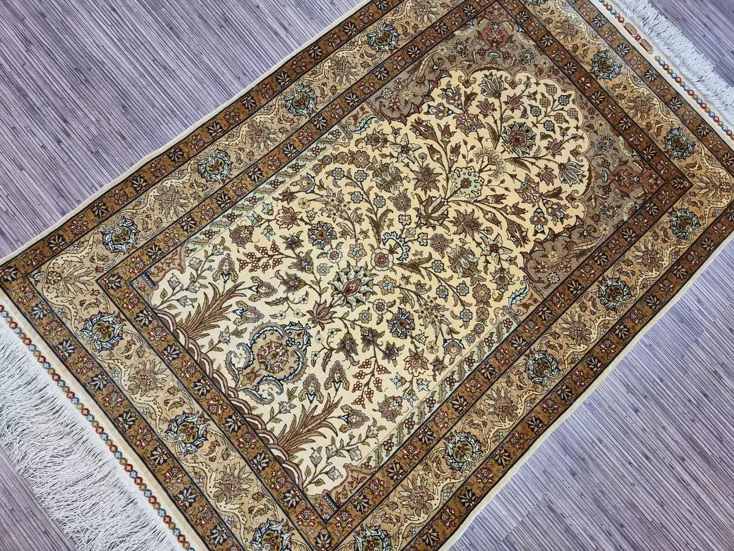 Rectangular Turkish Hereke rug with a distinctive prayer design