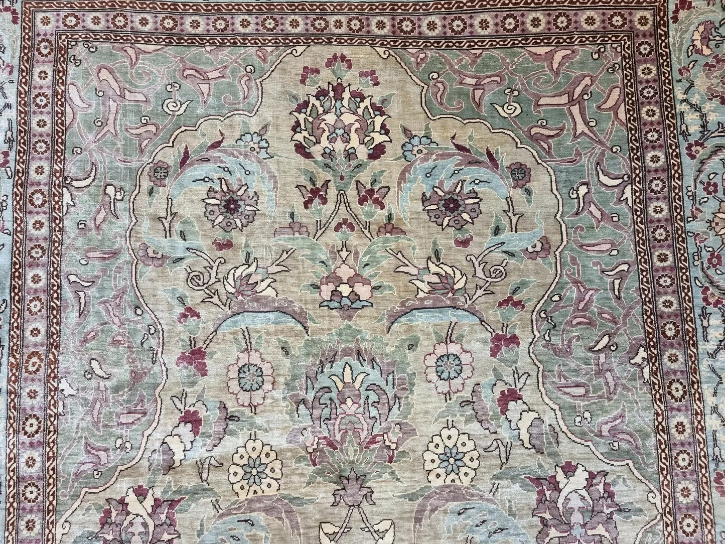 Vintage Turkish Hereke silk prayer rug with intricate floral patterns and a turquoise border