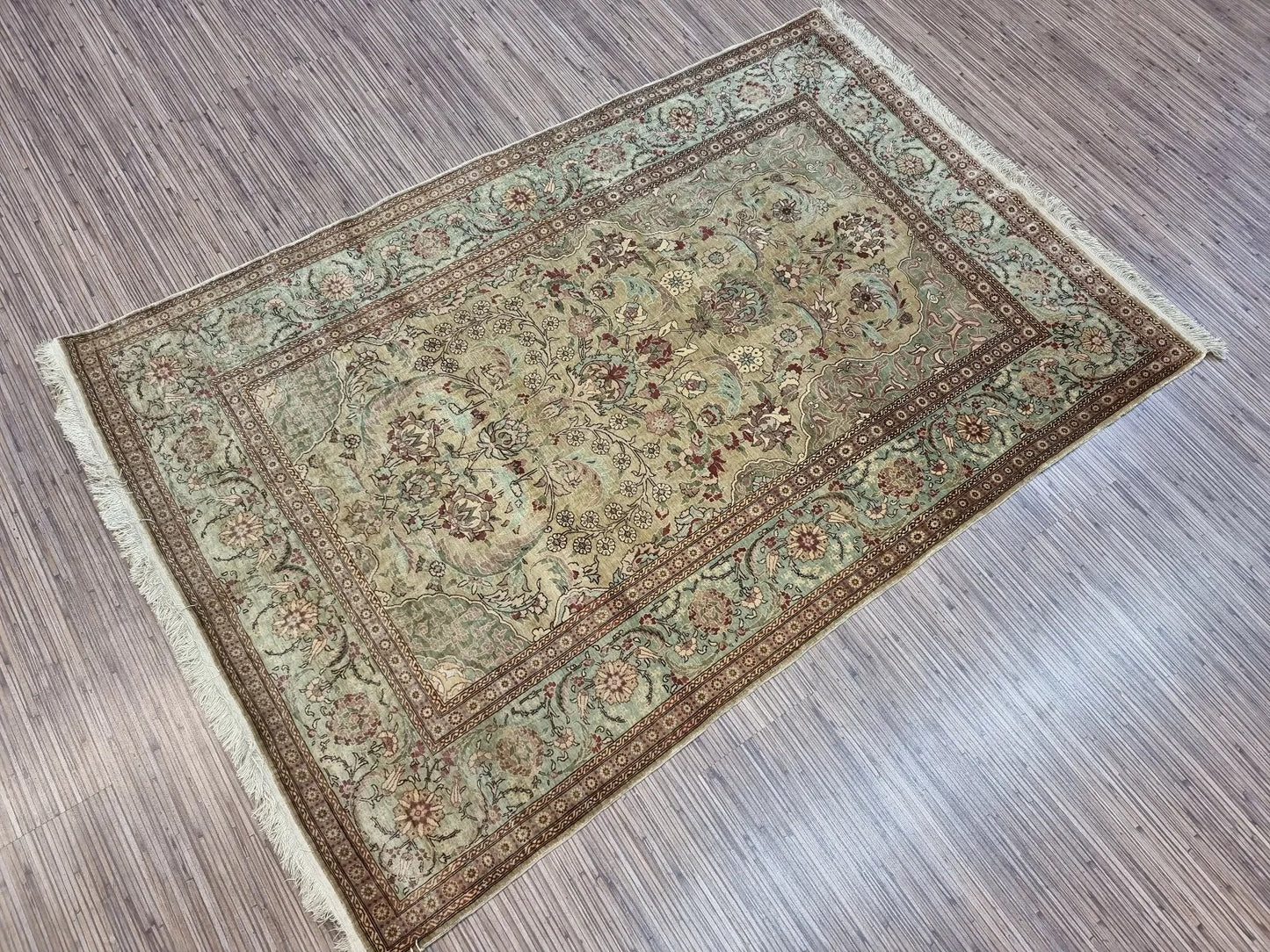 Detailed floral designs on the 1970s Hereke rug border