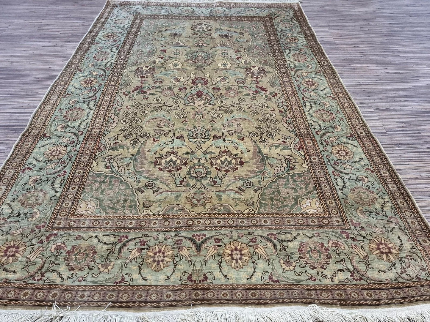 Hand-knotted silk prayer rug with vibrant colors and luxurious sheen