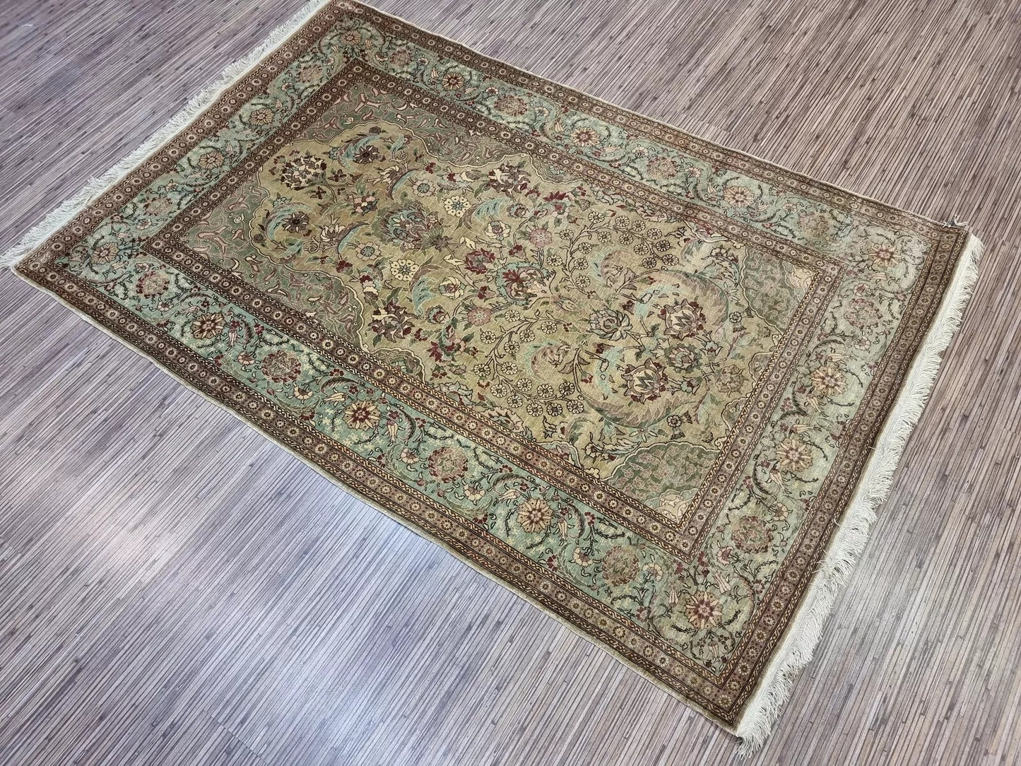 Hand-knotted silk prayer rug with vibrant colors and luxurious sheen