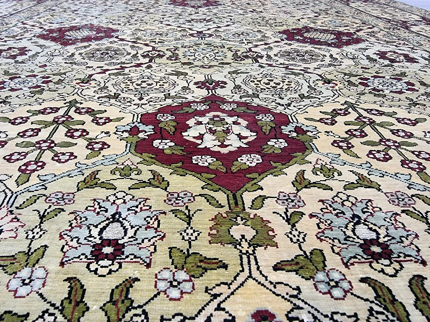 Perfectly preserved golden beige and burgundy tones on the silk rug