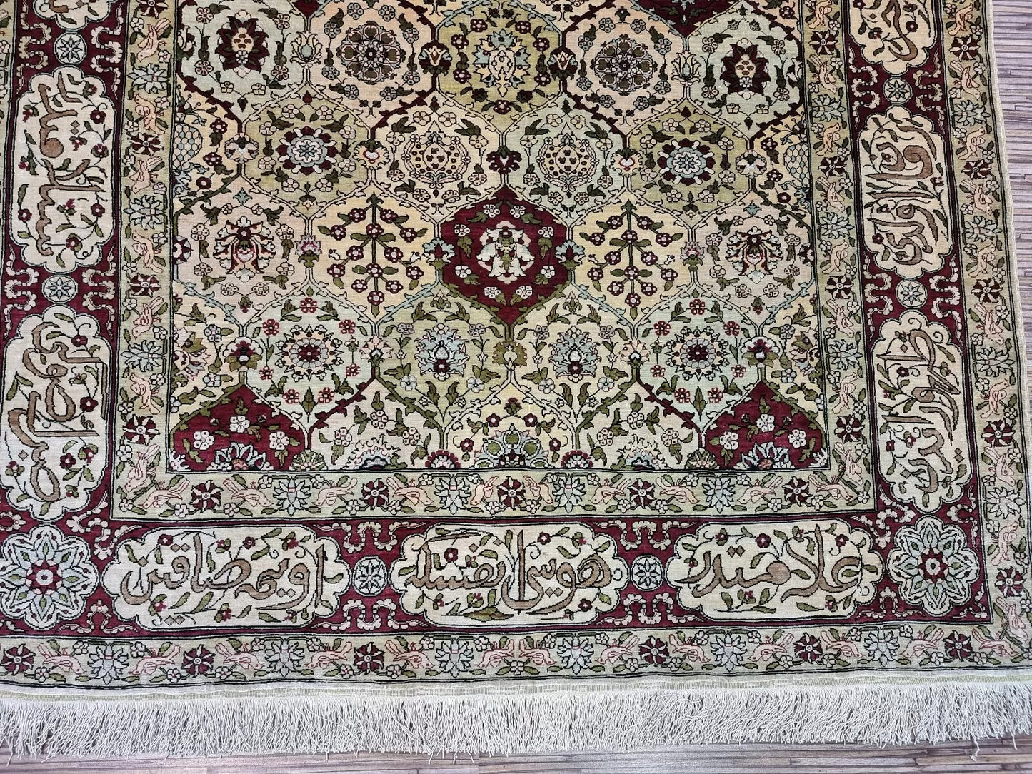 Detailed calligraphy-inspired border design on the vintage Turkish rug