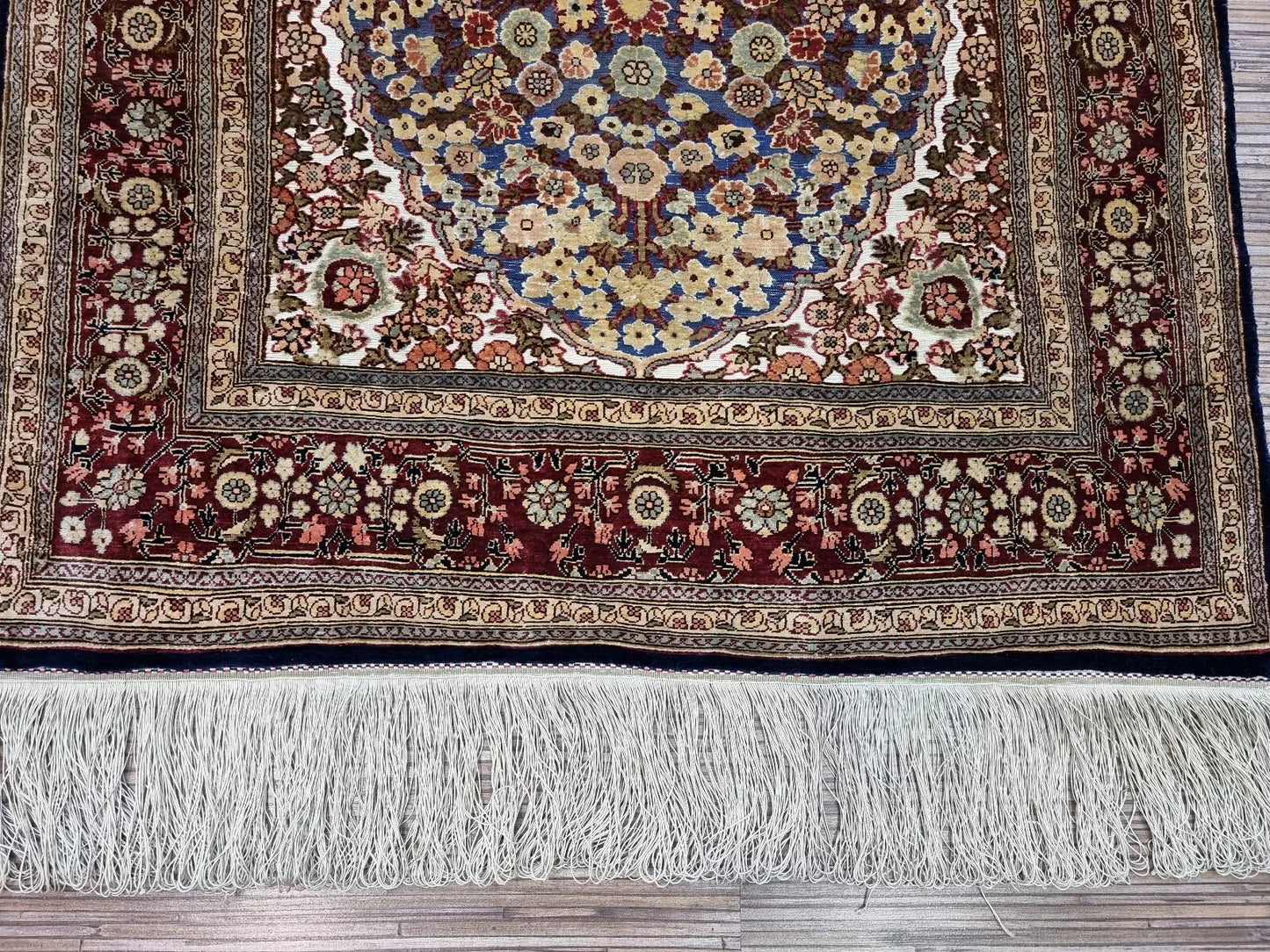 Artisan-signed Turkish Hereke silk rug, showcasing fine craftsmanship.