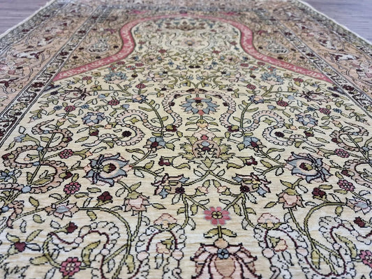 Close-up of prayer arch pattern on Hereke silk rug