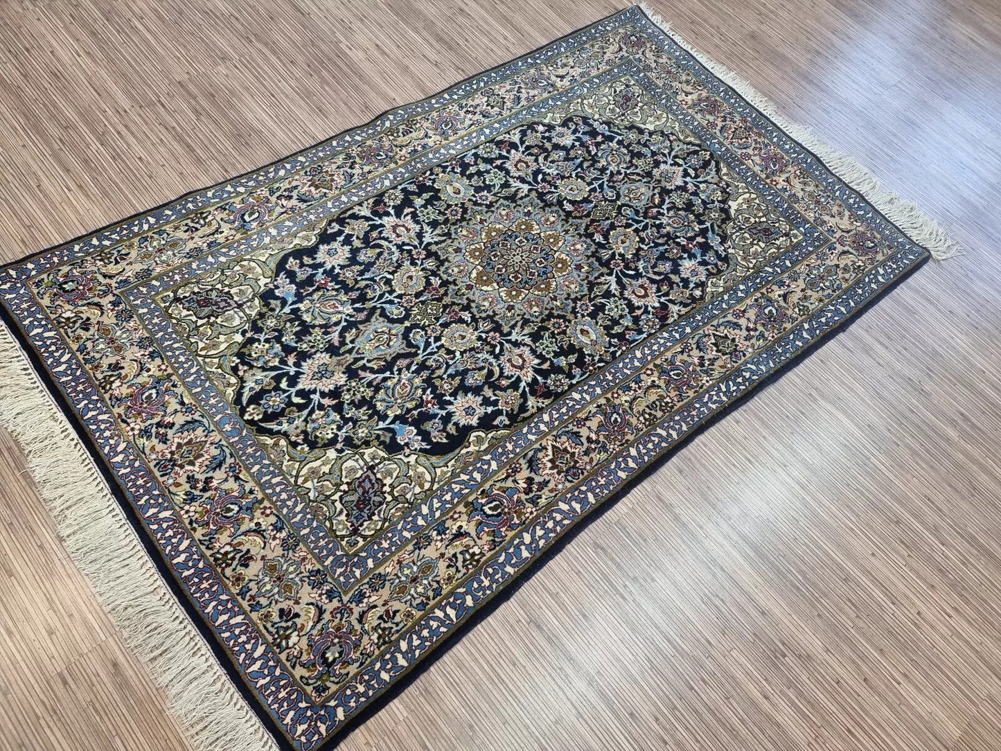 The rug’s ornate border design, enhancing its timeless beauty
