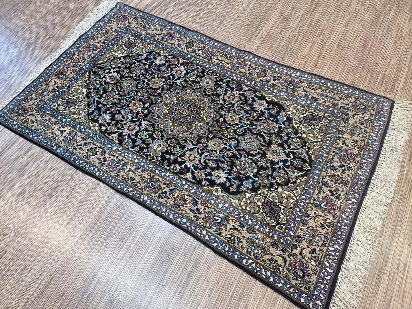 Antique Persian Isfahan rug displayed in a traditional home setting