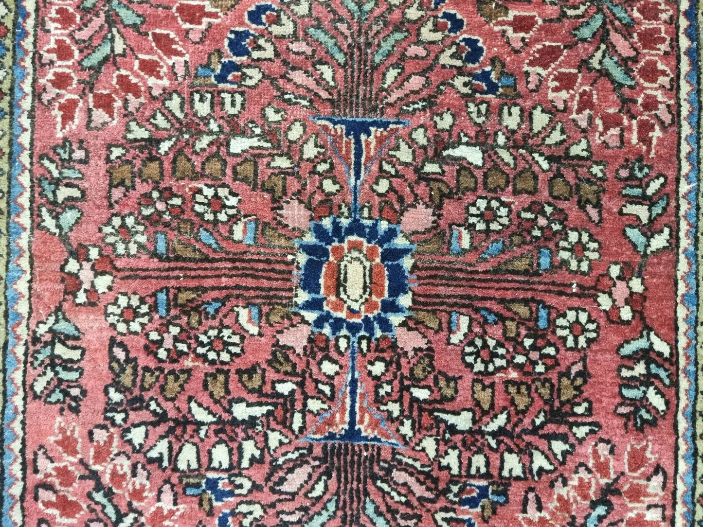 Aged patina and detailed craftsmanship on a Persian-style Sarouk rug