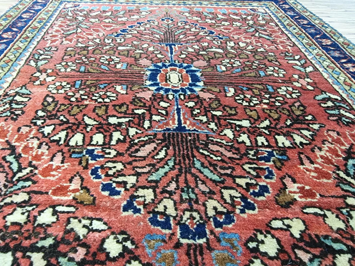 Rich red Persian-style rug with intricate traditional detailing