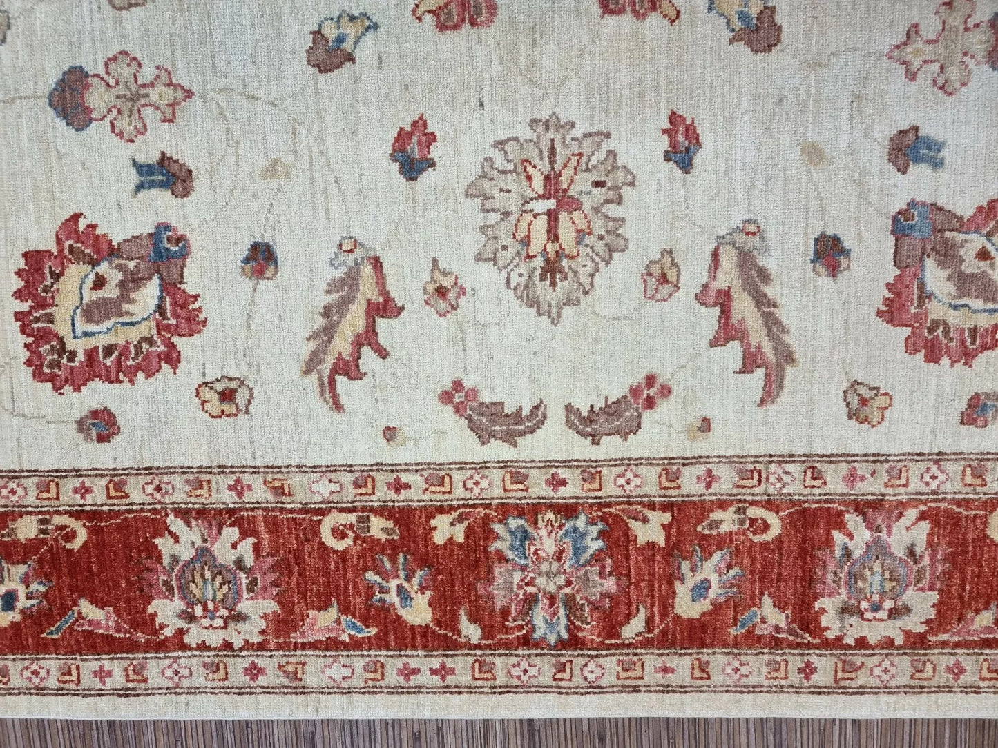 Handmade wool rug in soft cream and rust tones