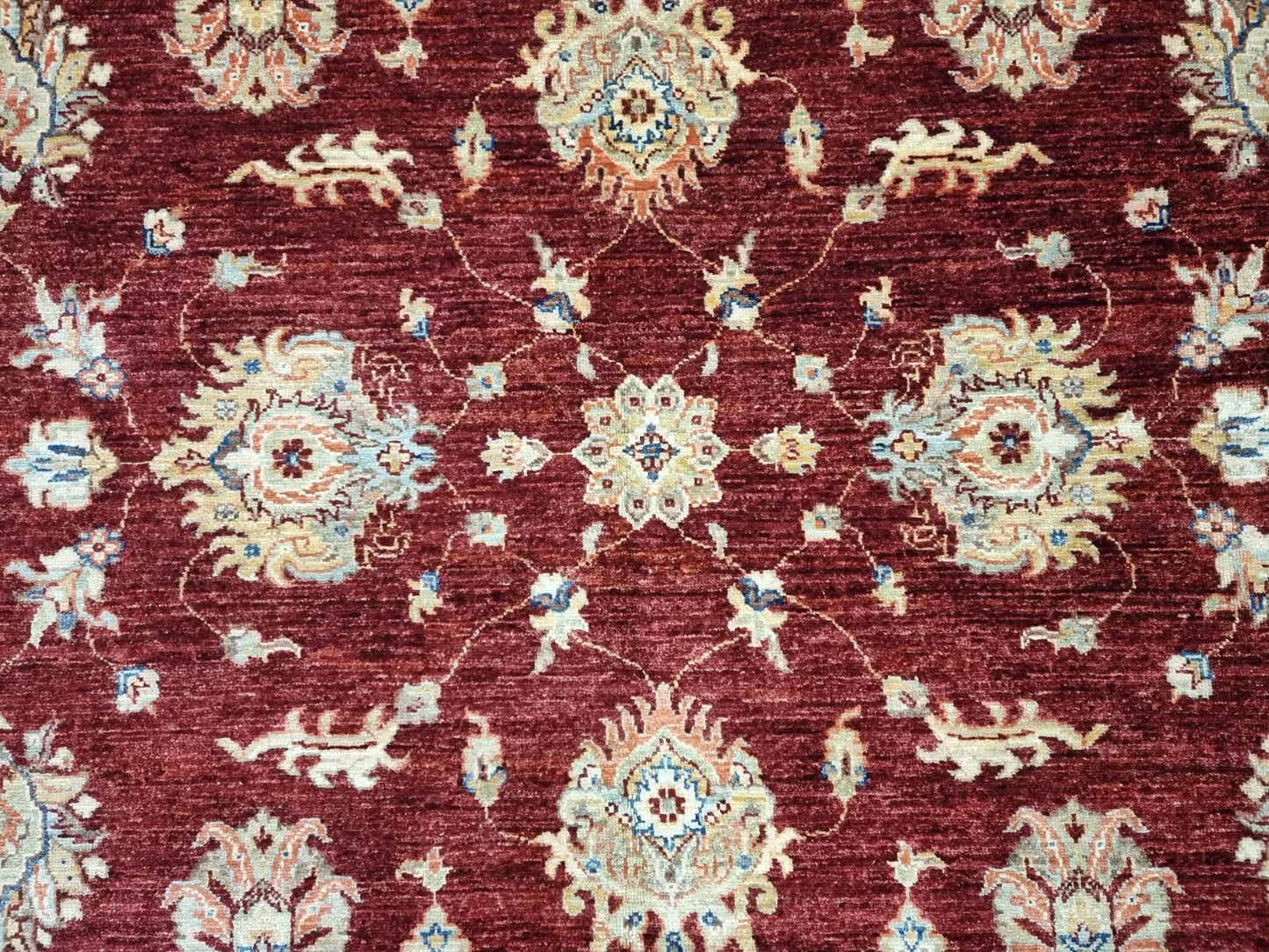 Room-sized Afghan rug with warm earth colors