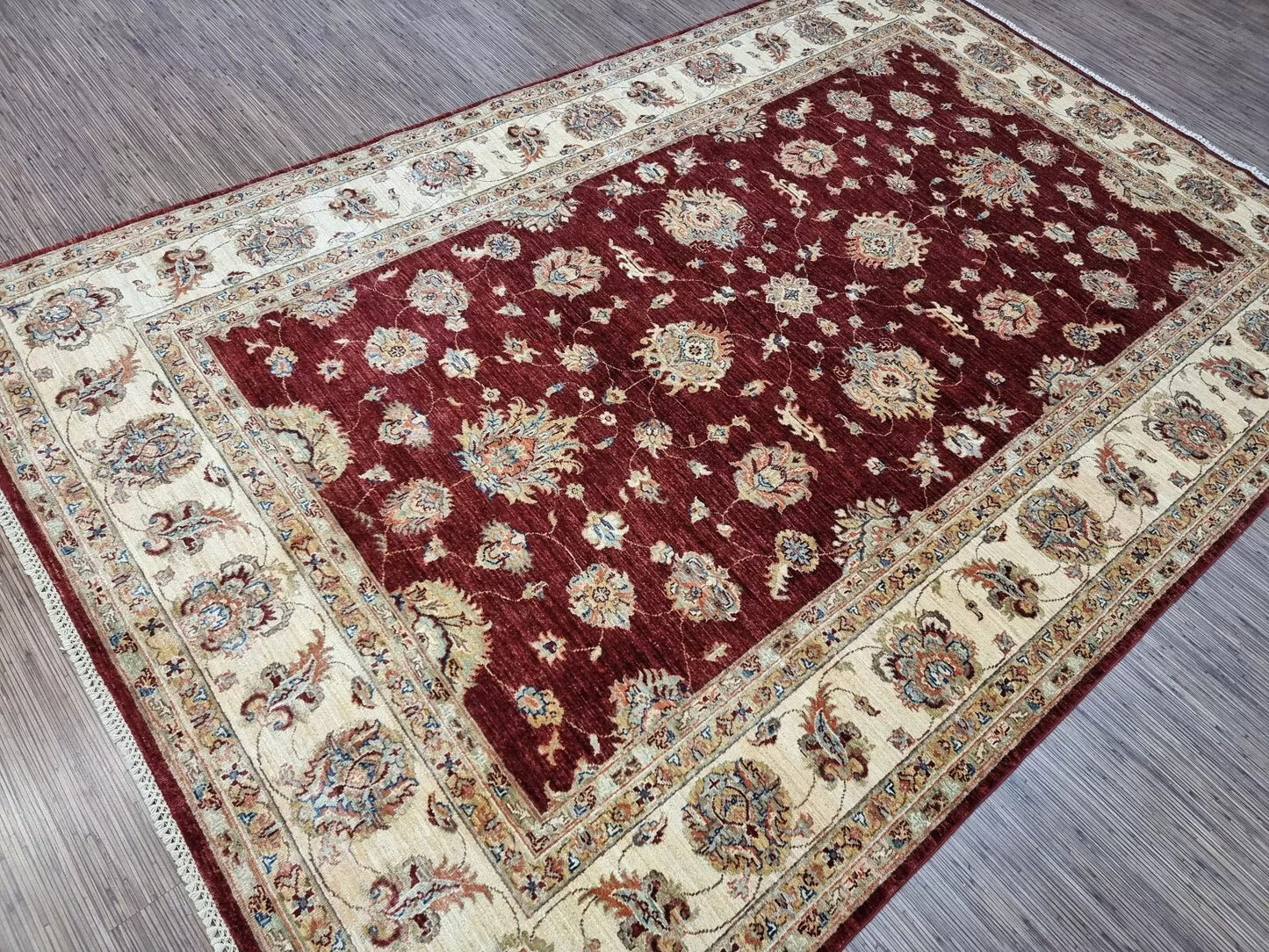 Soft woolen carpet with beige and green floral motifs