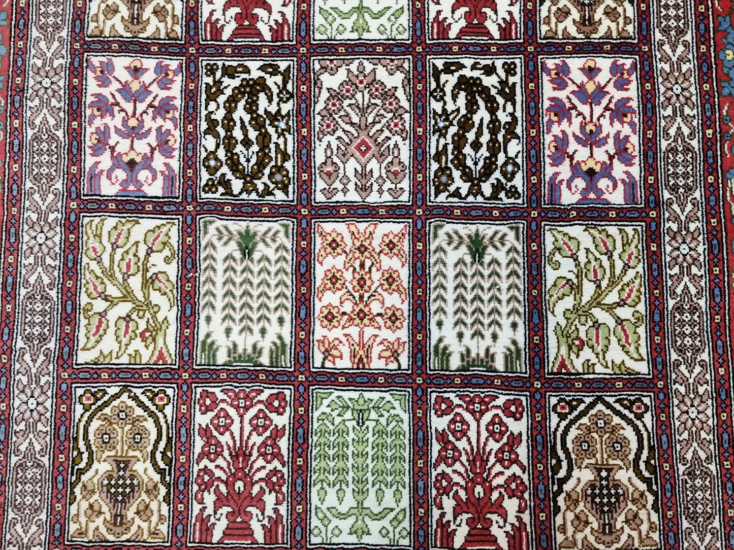 Close-up of floral Qum rug in ivory and red