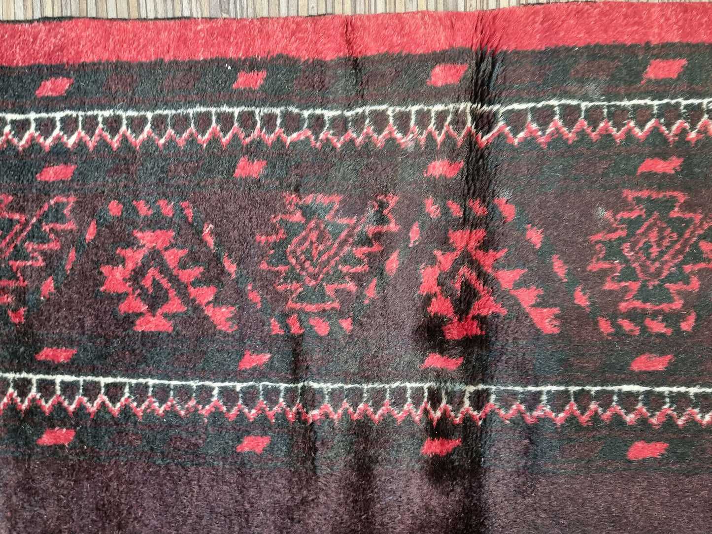 Breathe new life into your space with this vintage Afghan Baluch rug, a captivating conversation starter.