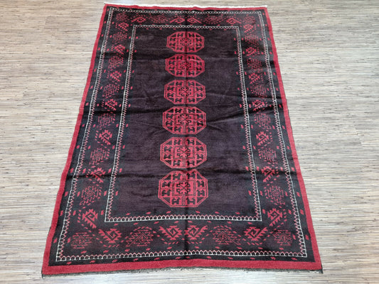 Step into a vintage dream with this handwoven Afghan Baluch rug, a masterpiece of geometric patterns and cultural heritage.