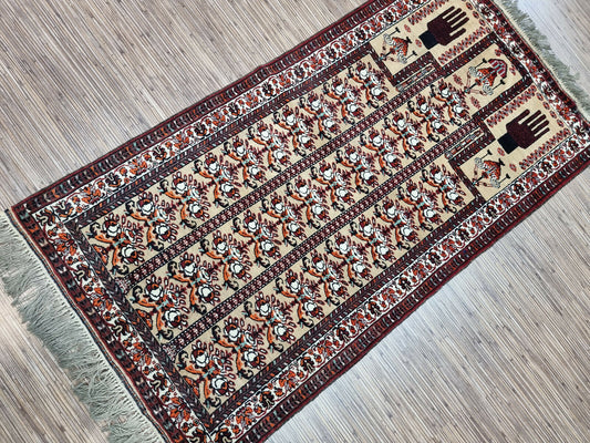 Handwoven Afghan rug, steeped in history, featuring intricate details and the hands of the worshipper.