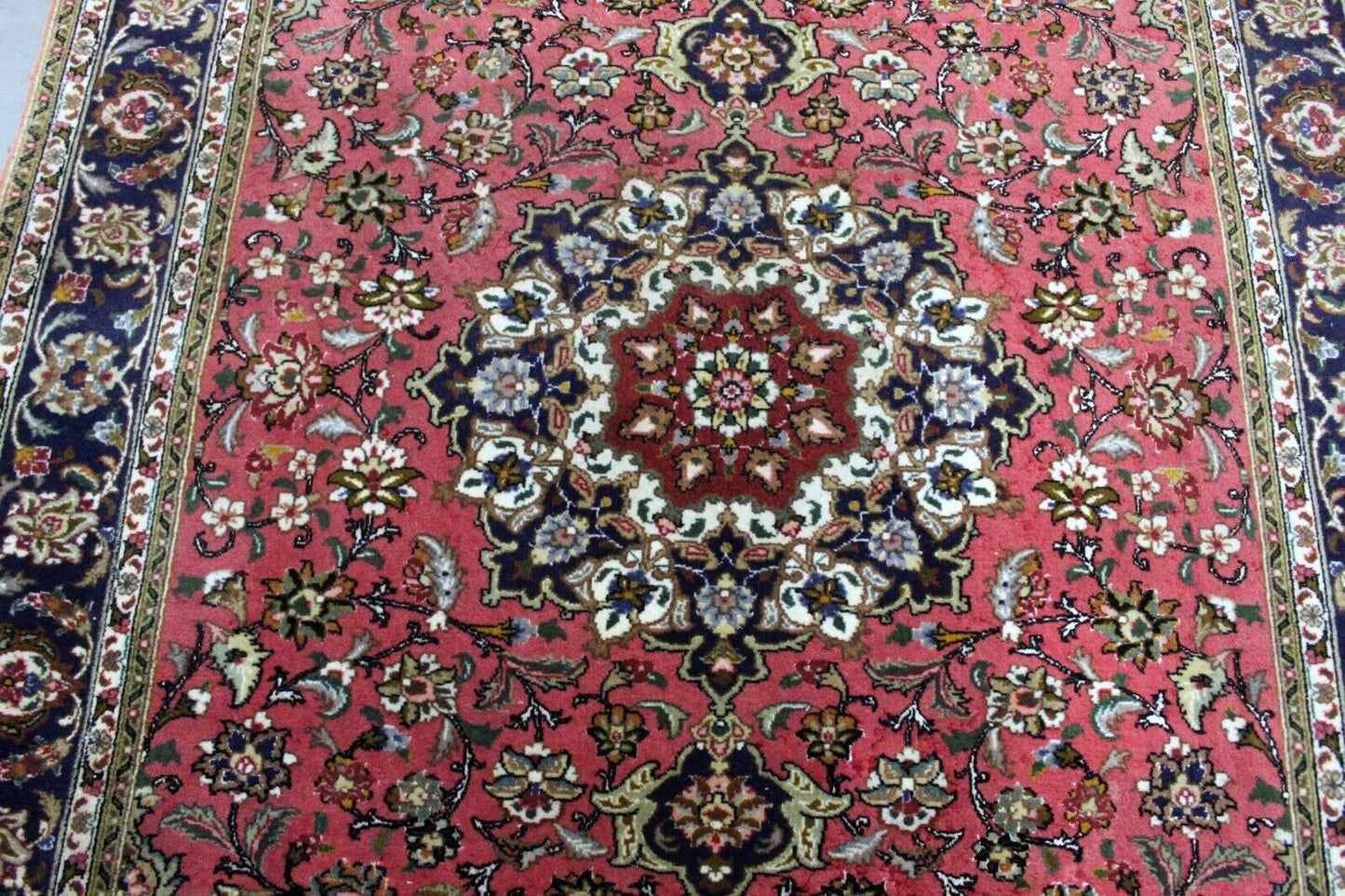 Close-up of floral motifs on Handmade Vintage Persian Tabriz Rug - Delicate flowers and vines intertwined in rich reds, blues, and greens.