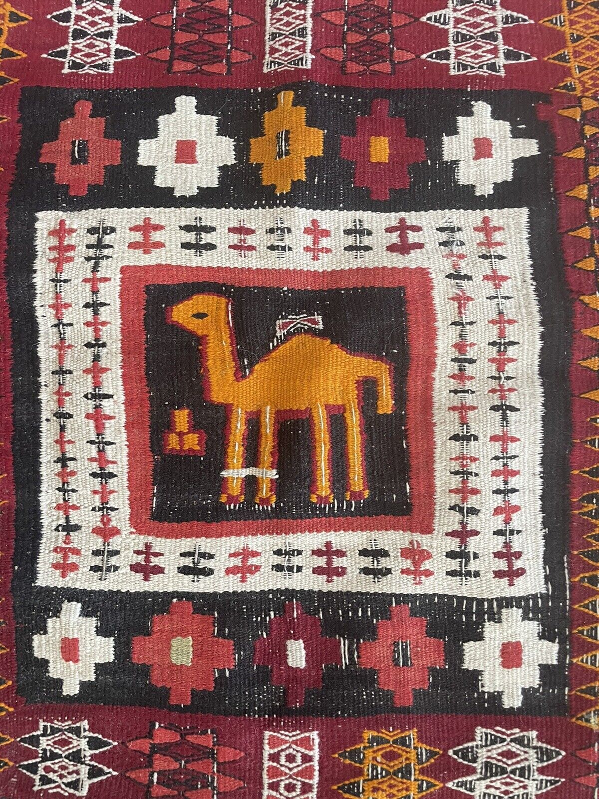 Close-up of color palette on Handmade Antique Moroccan Berber Kilim Rug - Detailed view showcasing the rich color palette of the rug, including dark red, black, white, yellow, and brown tones.